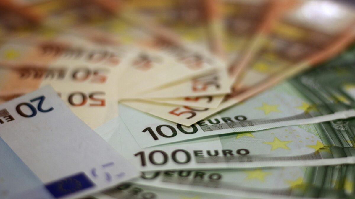 Close-up of various euro banknotes fanned out, symbolizing wealth and financial success.